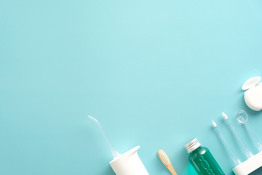 Dental care products with water flosser irrigator, mouthwash, dental floss & toothbrush.