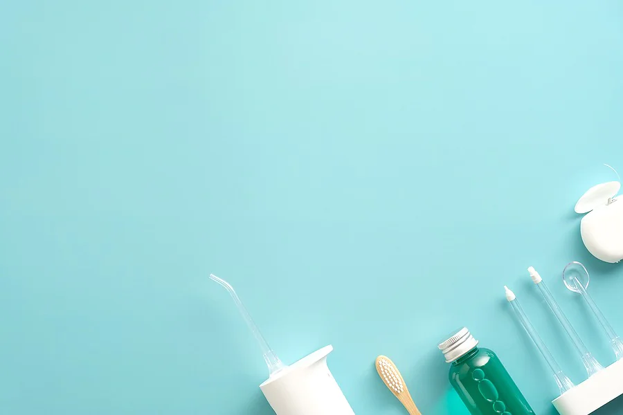 Dental care products with water flosser irrigator, mouthwash, dental floss & toothbrush.