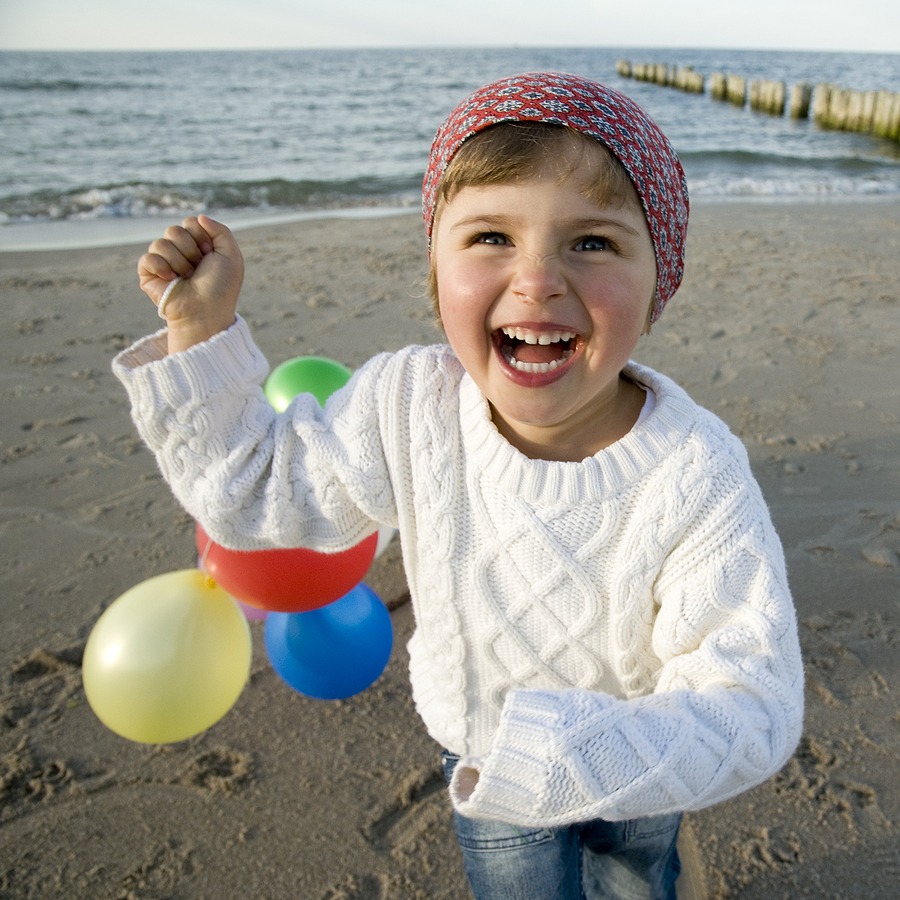 Child smiling at the beach