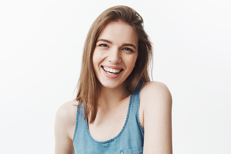 Young woman with big white teeth smiling